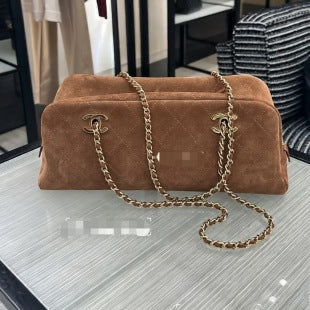 Brown suede Chanel bag with a gold chain