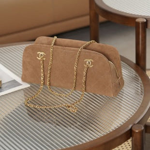 Brown suede Chanel bag with a gold chain