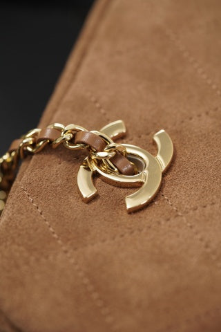Brown suede Chanel bag with a gold chain