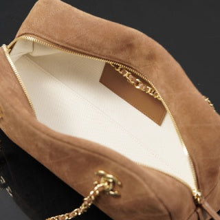 Brown suede Chanel bag with a gold chain