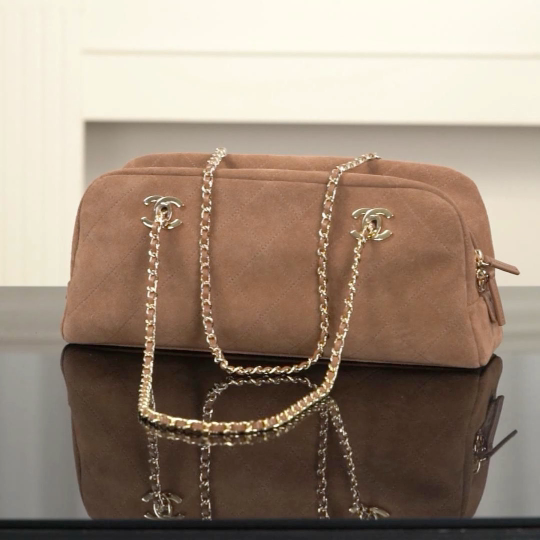 Brown suede Chanel bag with a gold chain