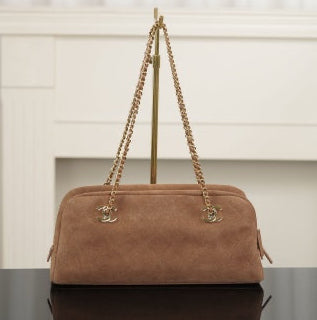 Brown suede Chanel bag with a gold chain